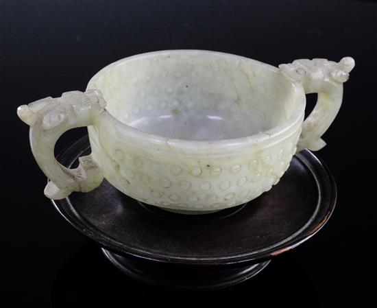 A Chinese celadon jade two handled cup, 17th century, width 12.5cm, rosewood stand